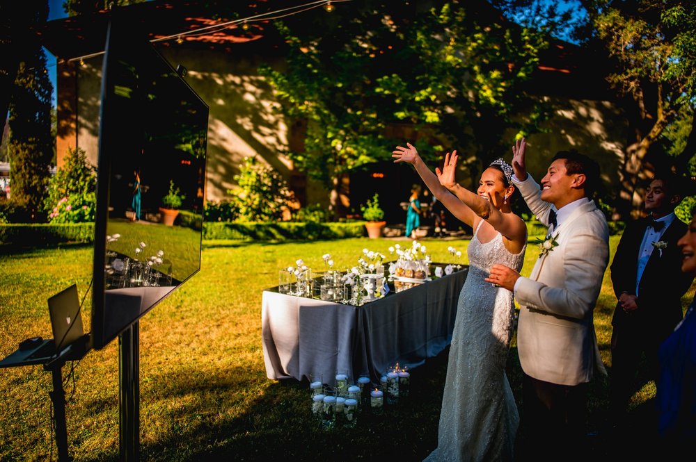 bride and groom waving hello to the family over Zoom