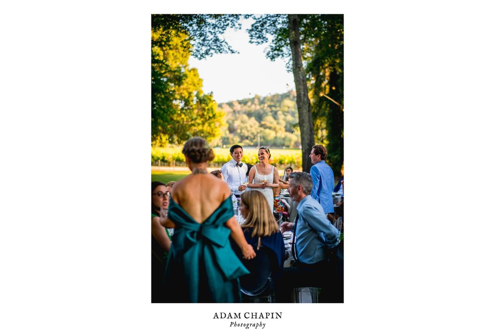 bride and groom spending time and talking with family and friend before dinner