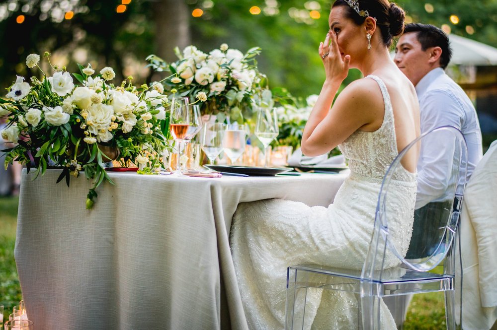 the bride is crying after hearing an emotionally touching speech from a friend at her wedding