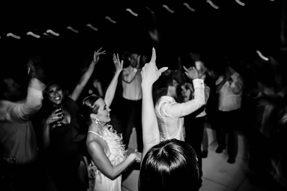 wedding guests dance with the bride and groom during the wedding recepetion