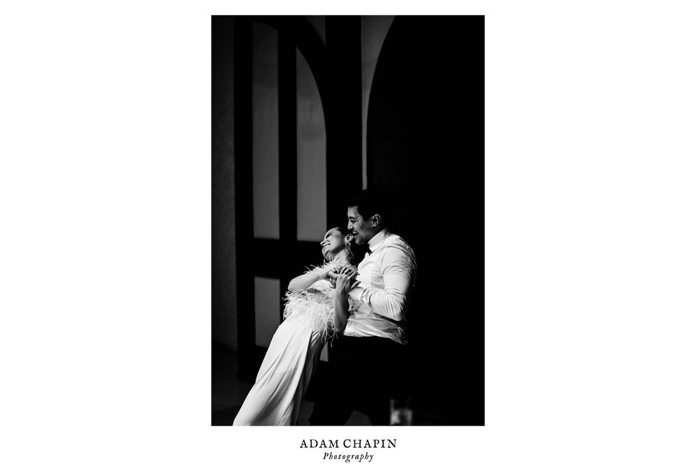 the bride and groom share a private dance and laugh together during their wedding