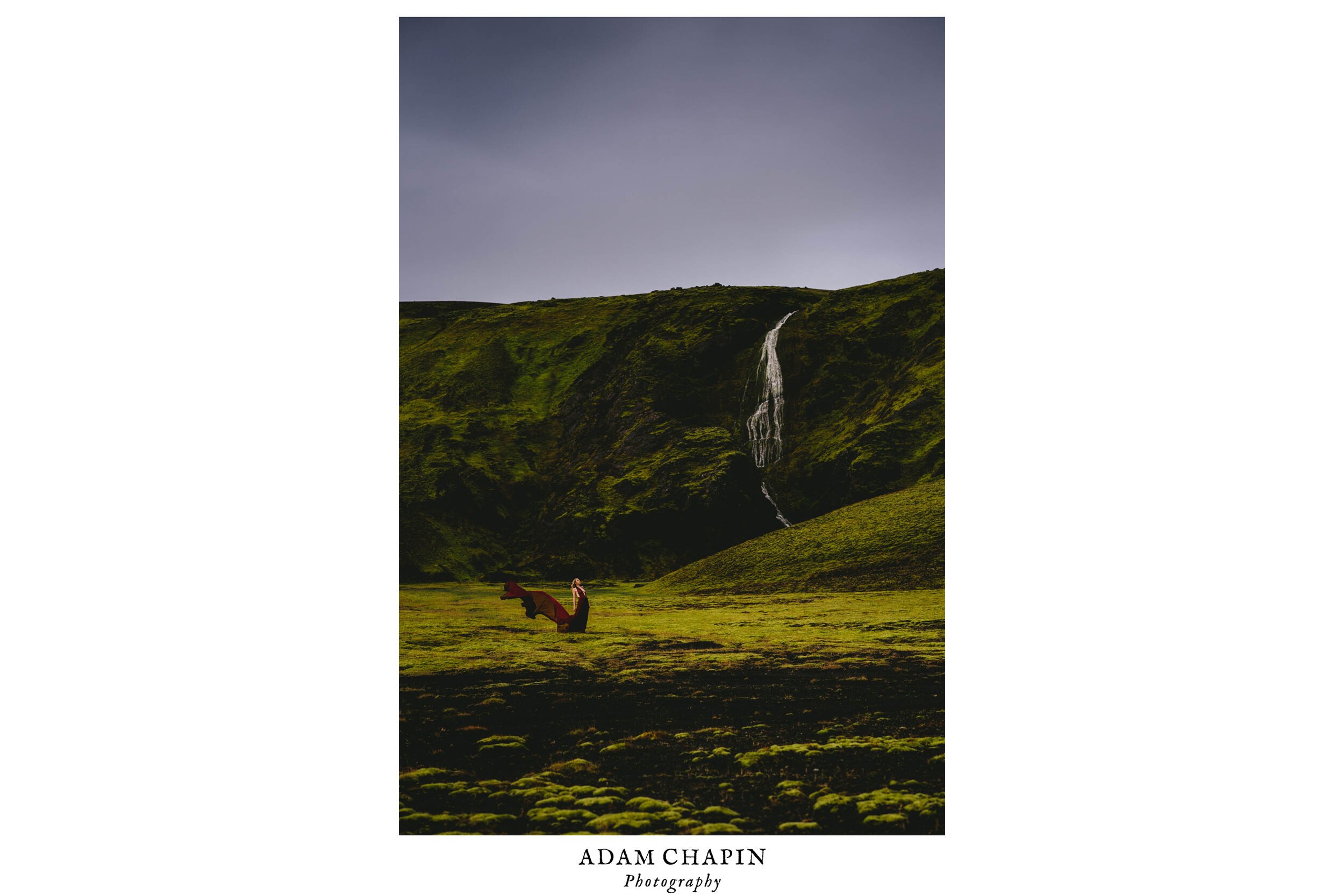a bride stands in front of a waterfall in inner Iceland