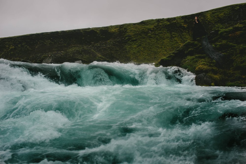 standing at the edge of a waterfall outside Reykjavík