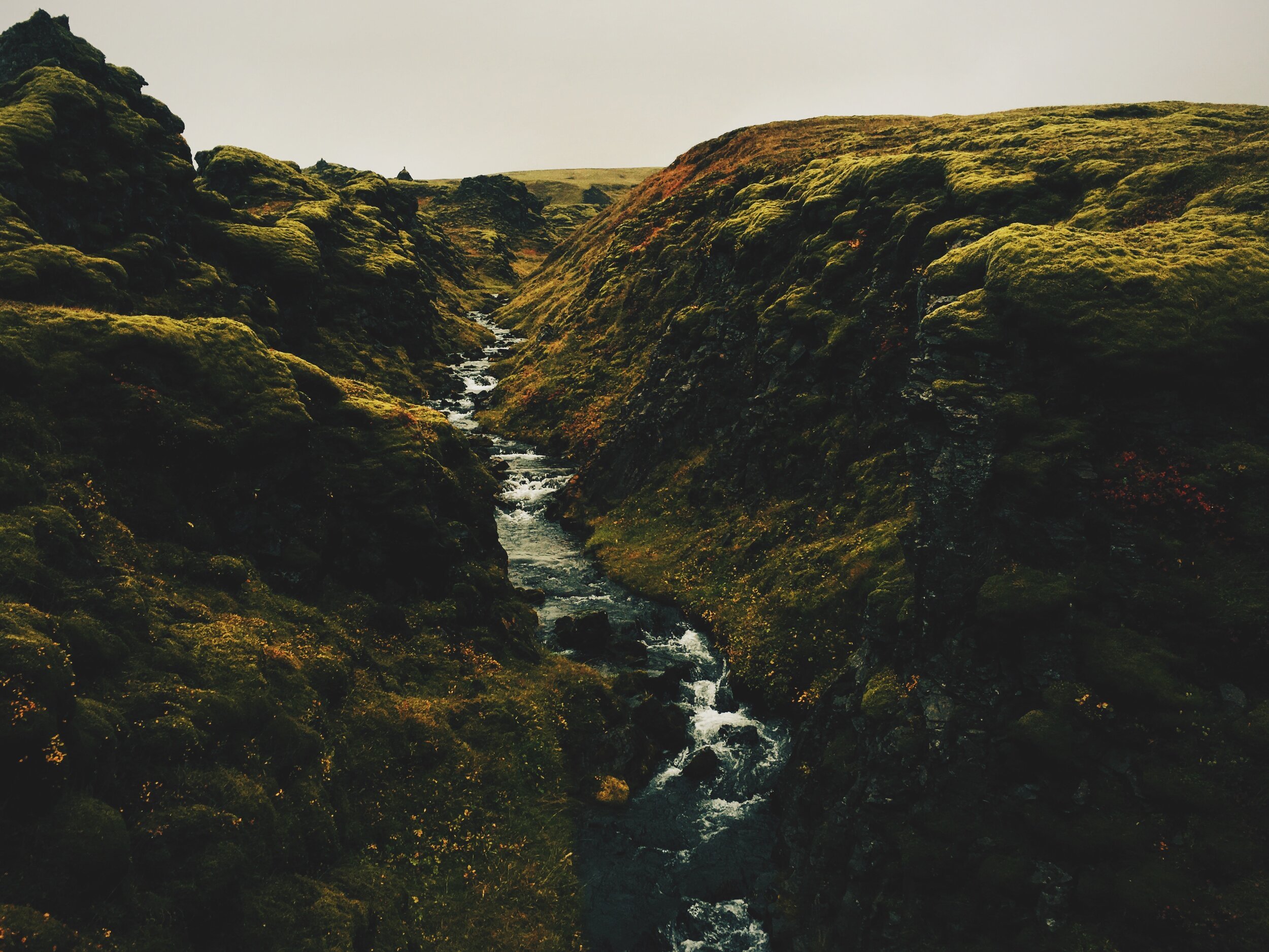 moss valley and stream outside near Huldafoss waterfall 