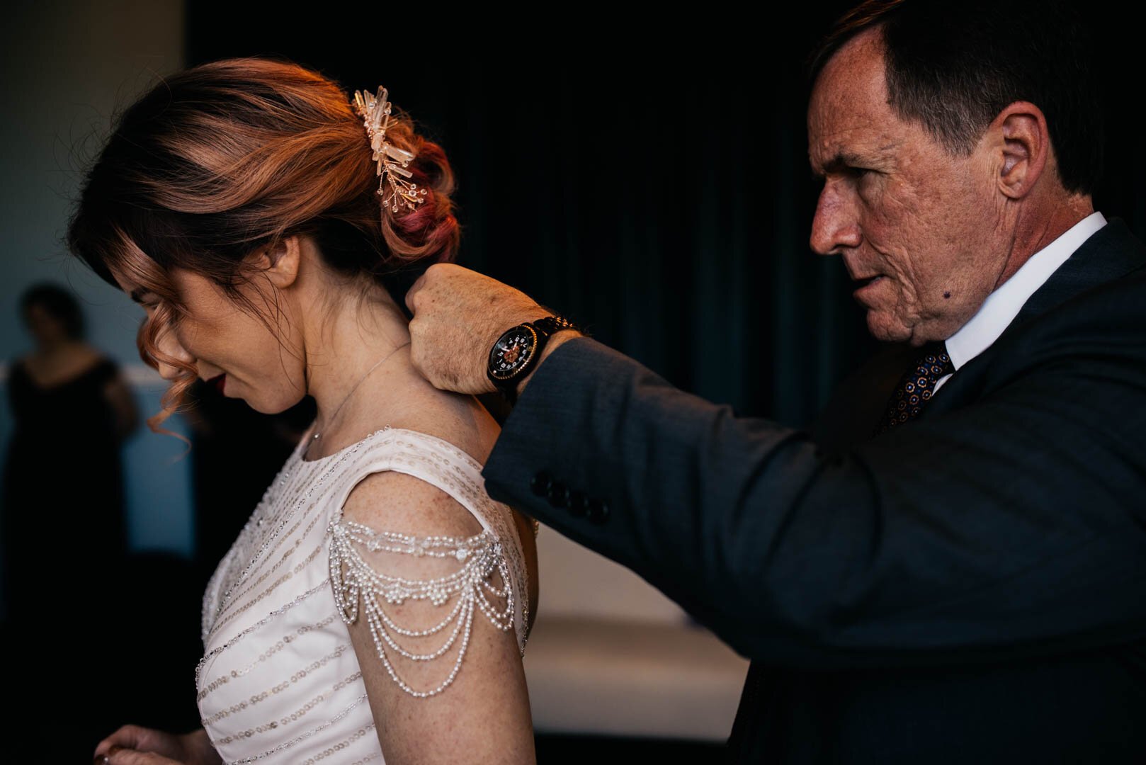 father of the bride put necklace on his daughter
