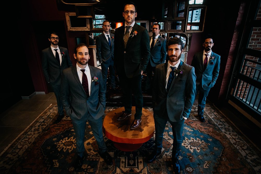 groomsmen pose for a formal portrait