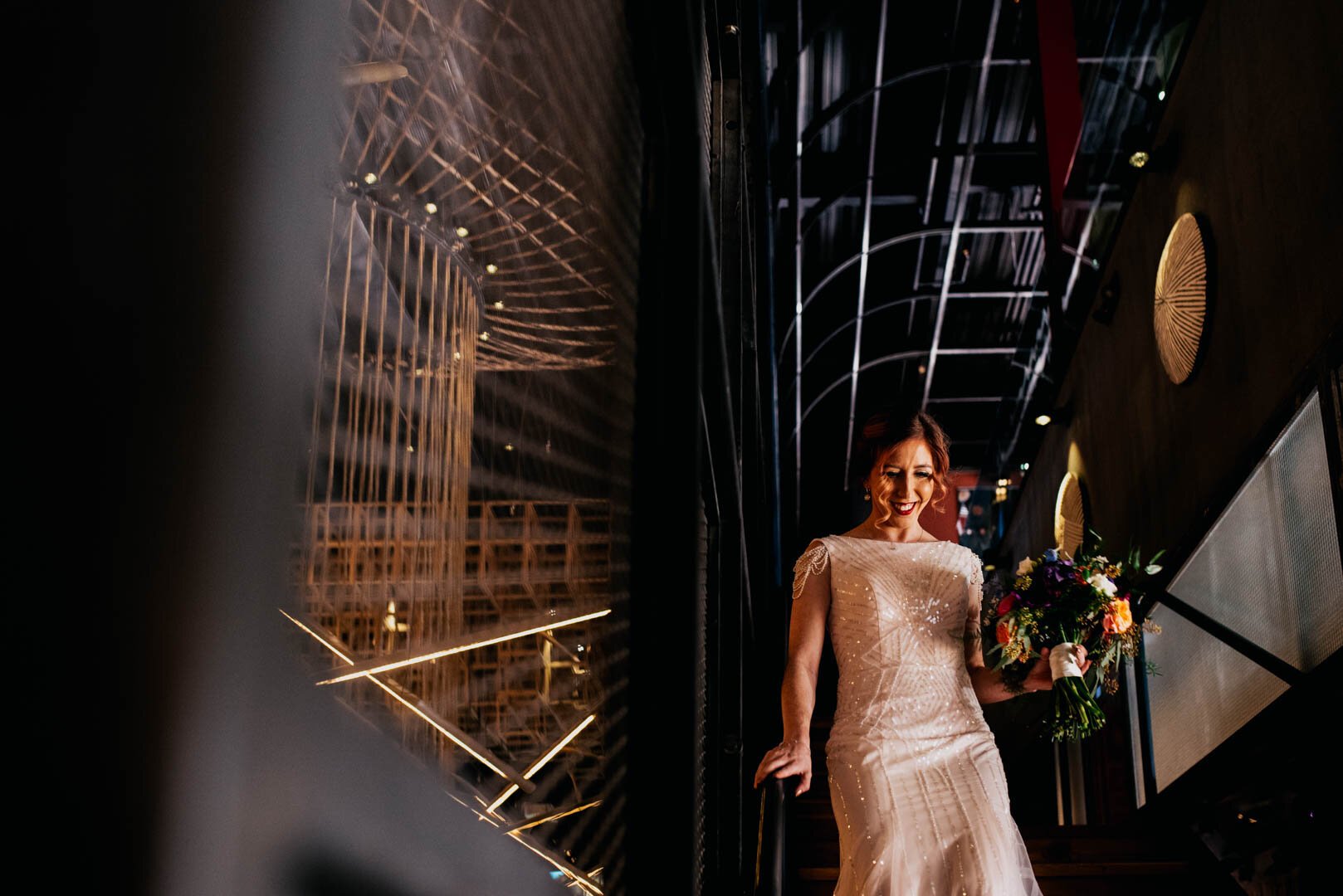 bride coming down stairs on her way to the first look