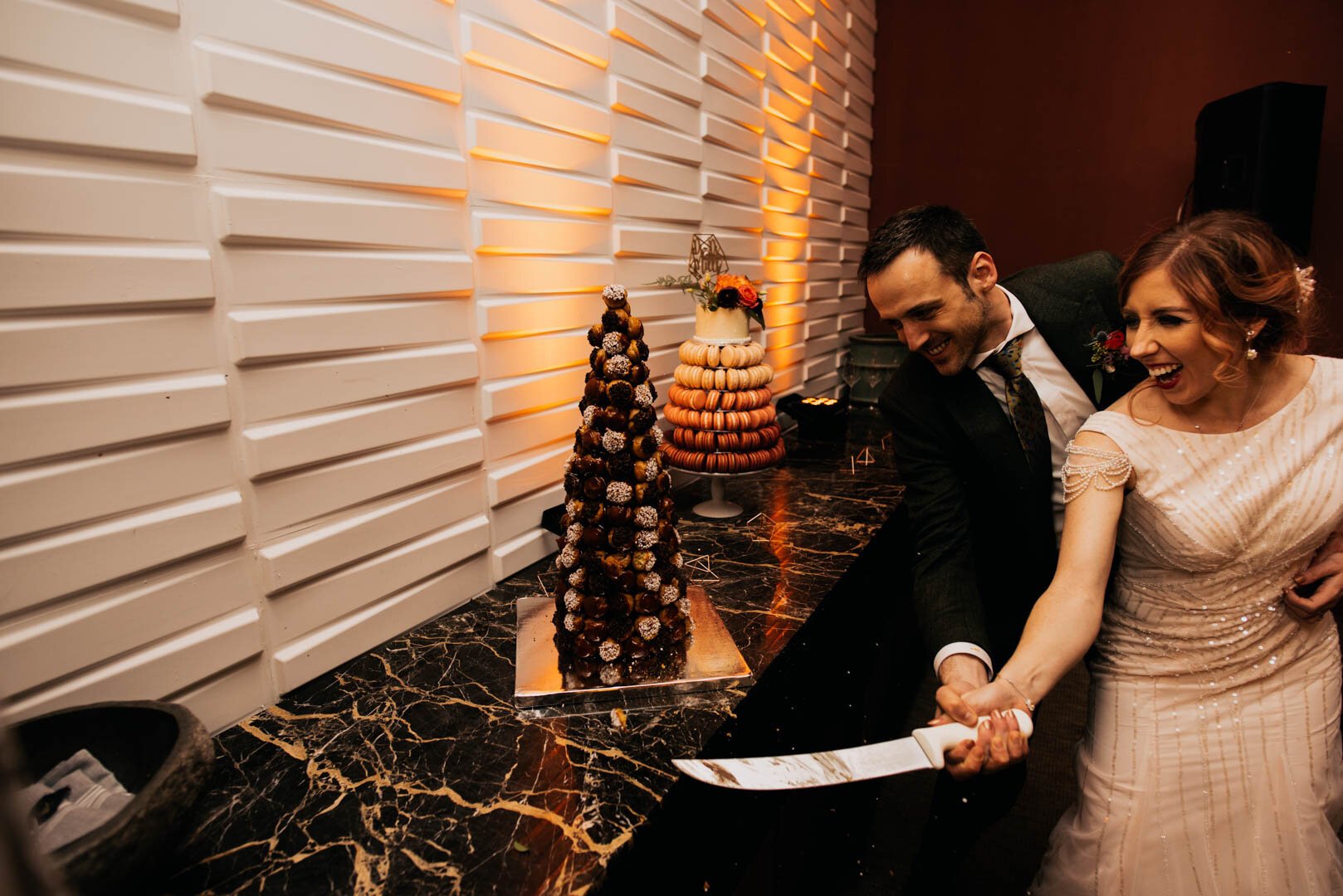 bride and groom sabering the wedding cake