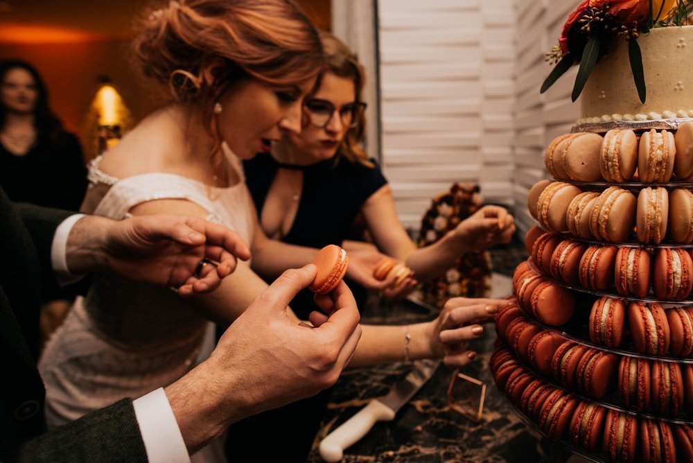 bride and bridesmaid pull macarons off to eat