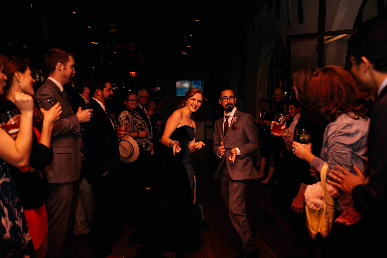 bridesmaid and groomsman dancing into the reception