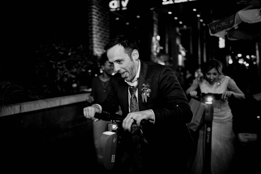 groom rides off on his Lime scooter while bride follows