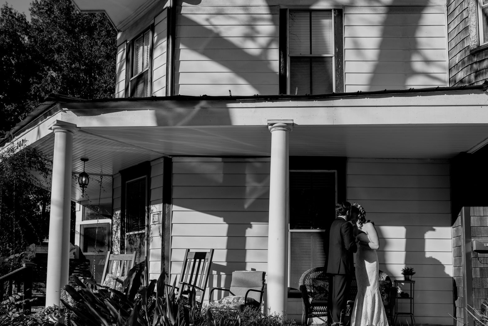 bride and groom embracing on porch during first look