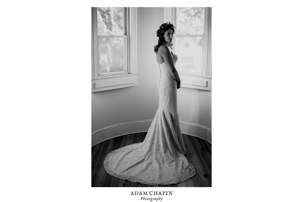 bride posed in beautiful wedding dress by the window