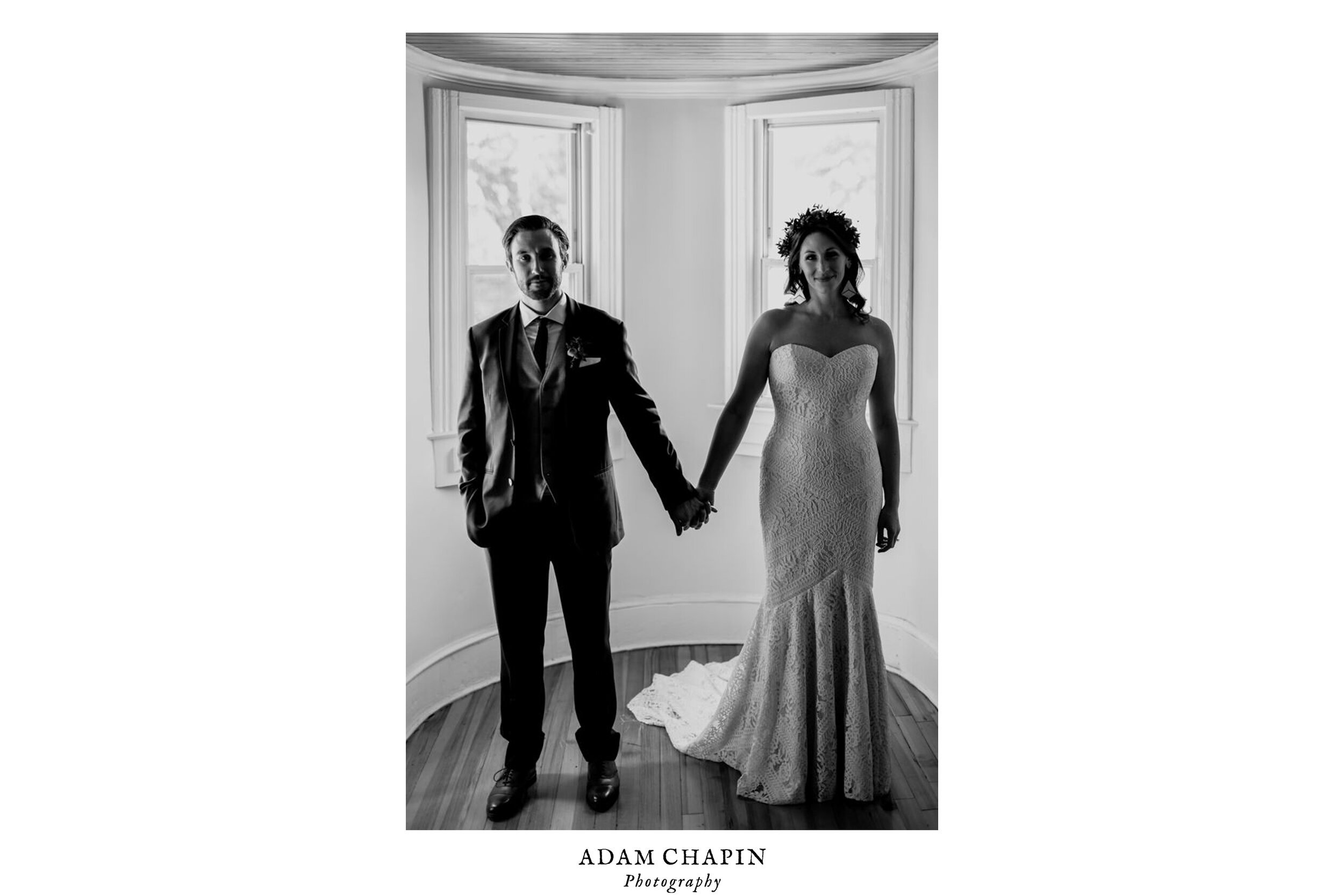 bride and groom doing the hipster hand hold pose in the turret room of old home