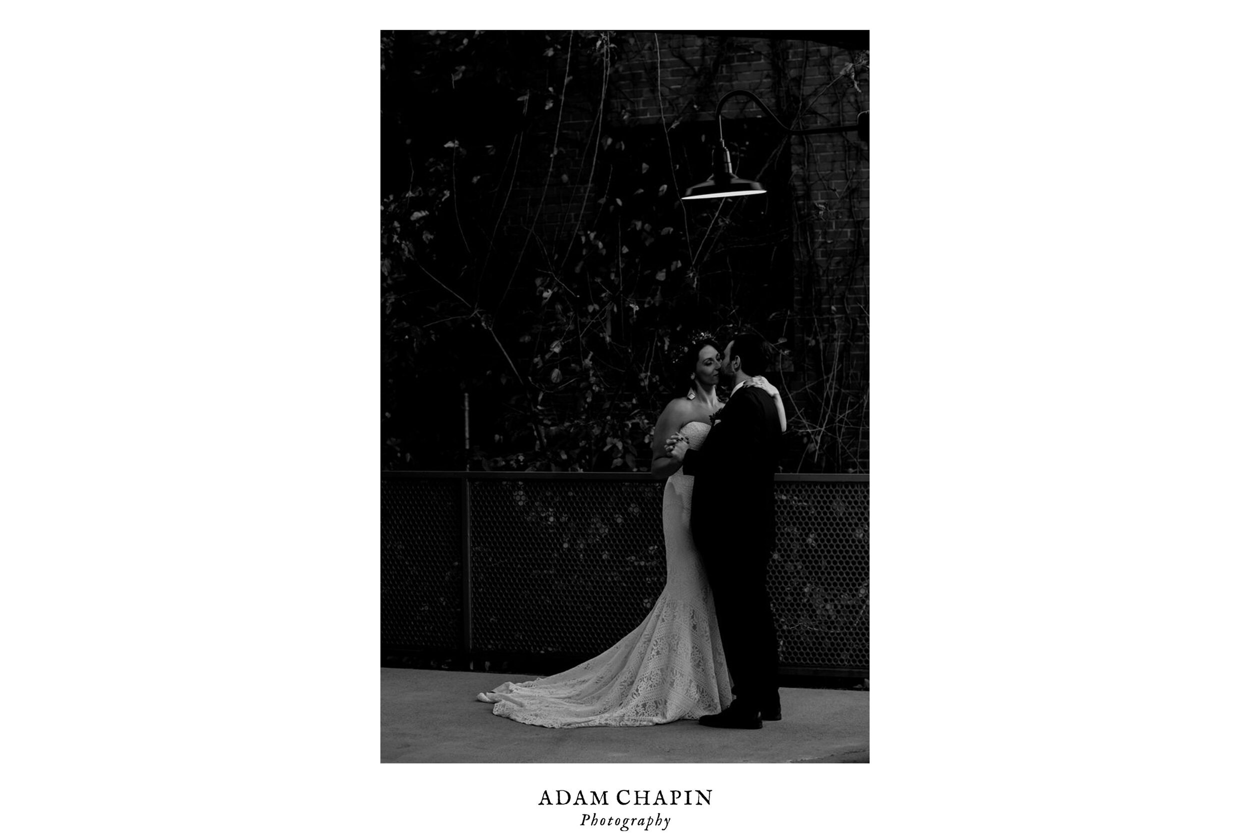 bride and groom dancing together under a light at the Rickhouse