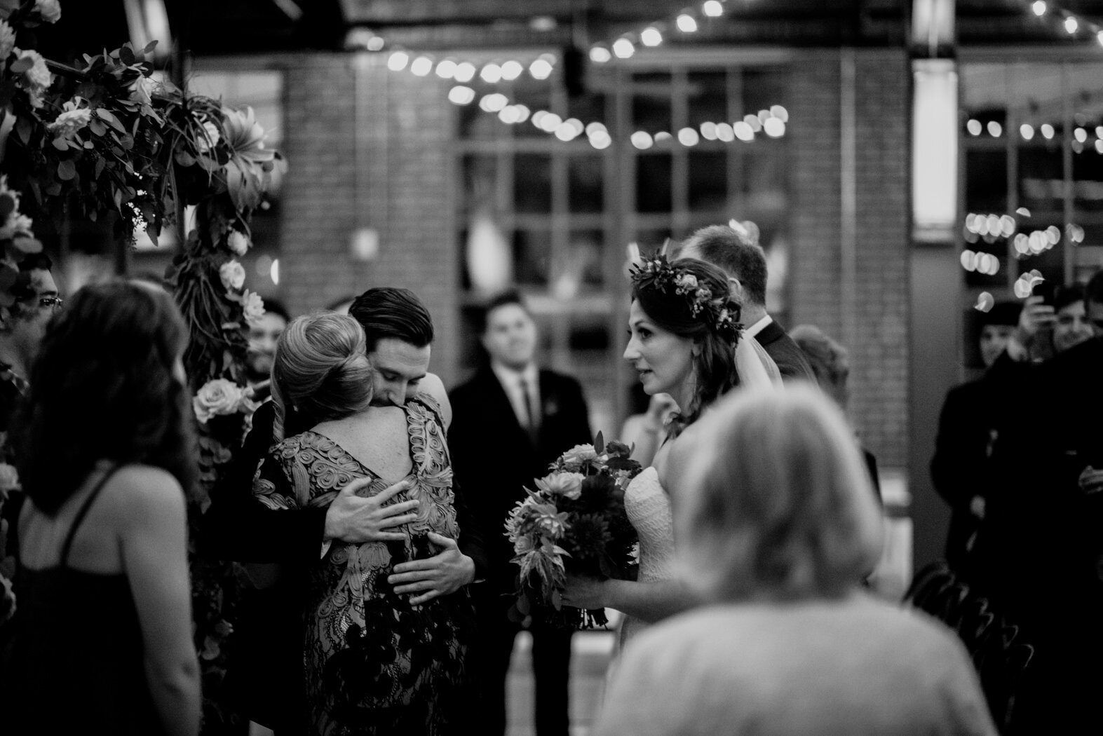 the mother of the bride hugging the groom at the beginning of the wedding ceremony