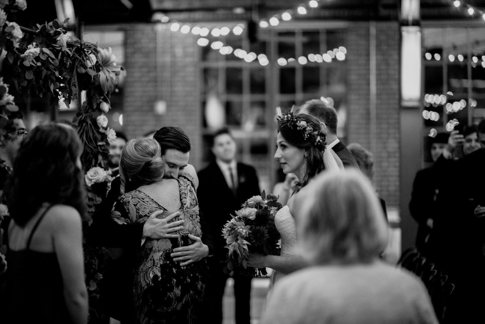 the mother of the bride hugging the groom at the beginning of the wedding ceremony