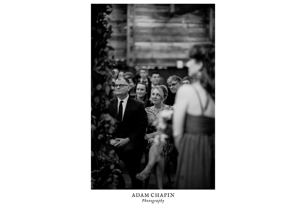 the parents of the bride look on during the wedding ceremony