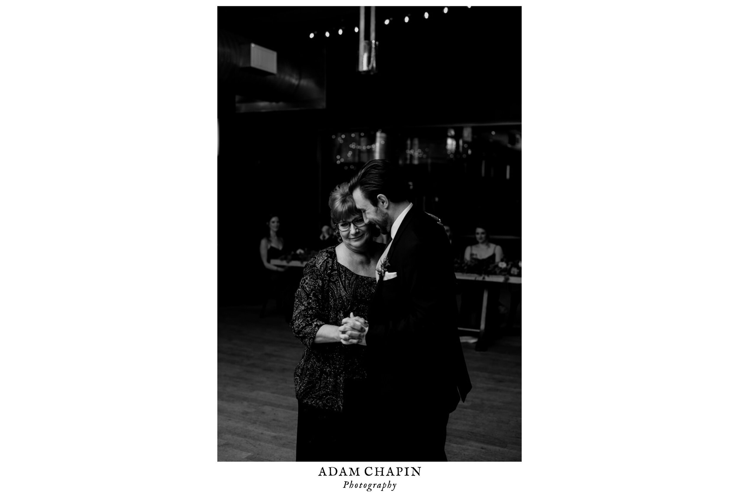 the groom smiling with his mom during the mother-son dance