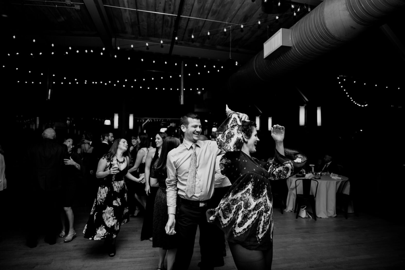wedding guests spinning each other during the reception