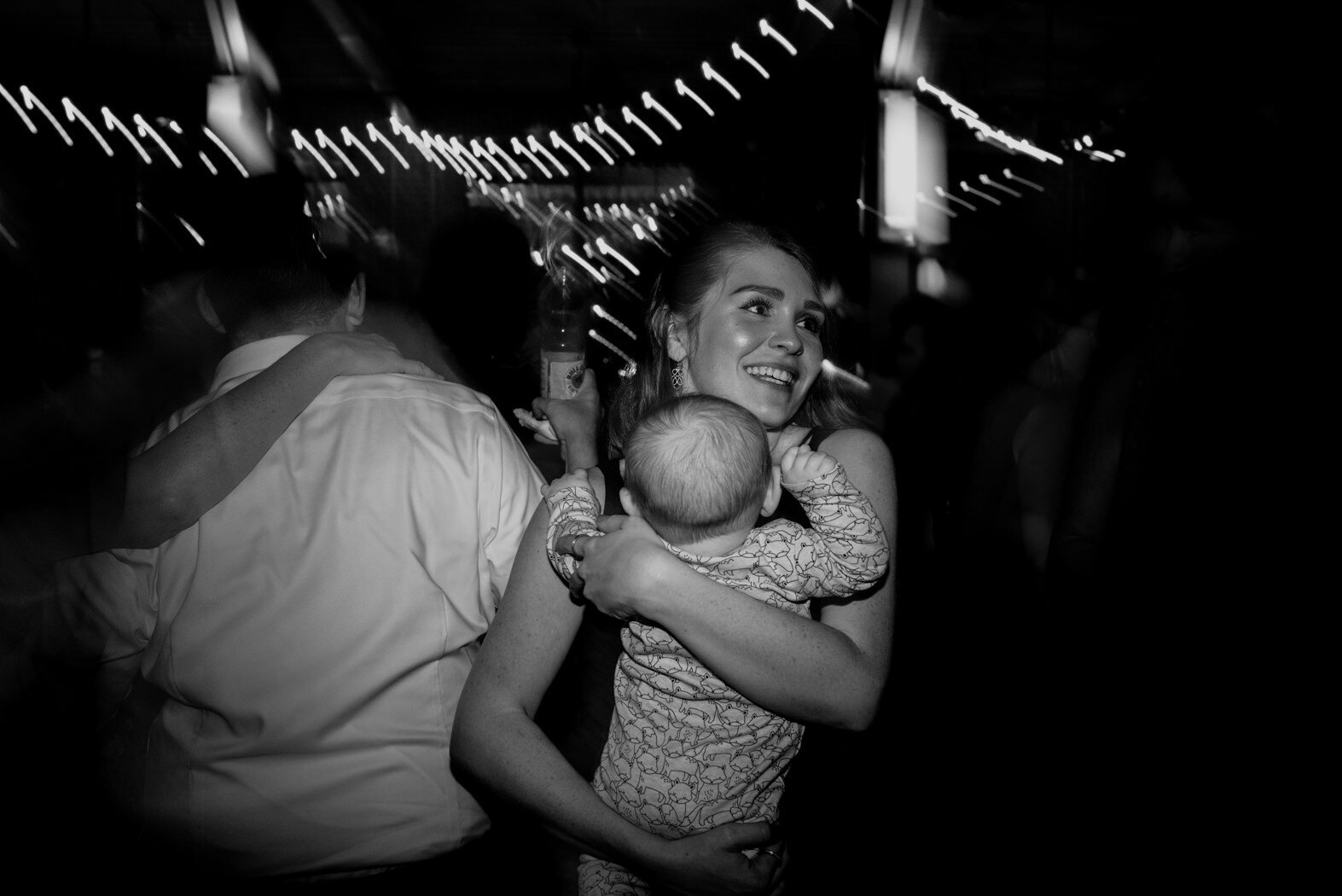 a mother and her baby dancing during the reception