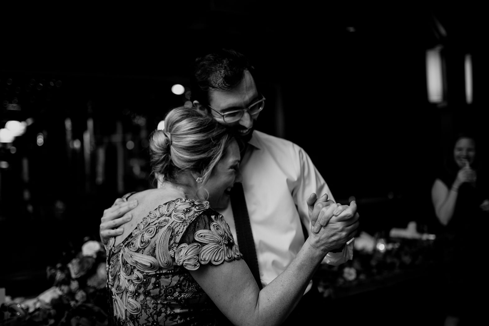 the mother of the bride and the best man sharing a dance during the reception