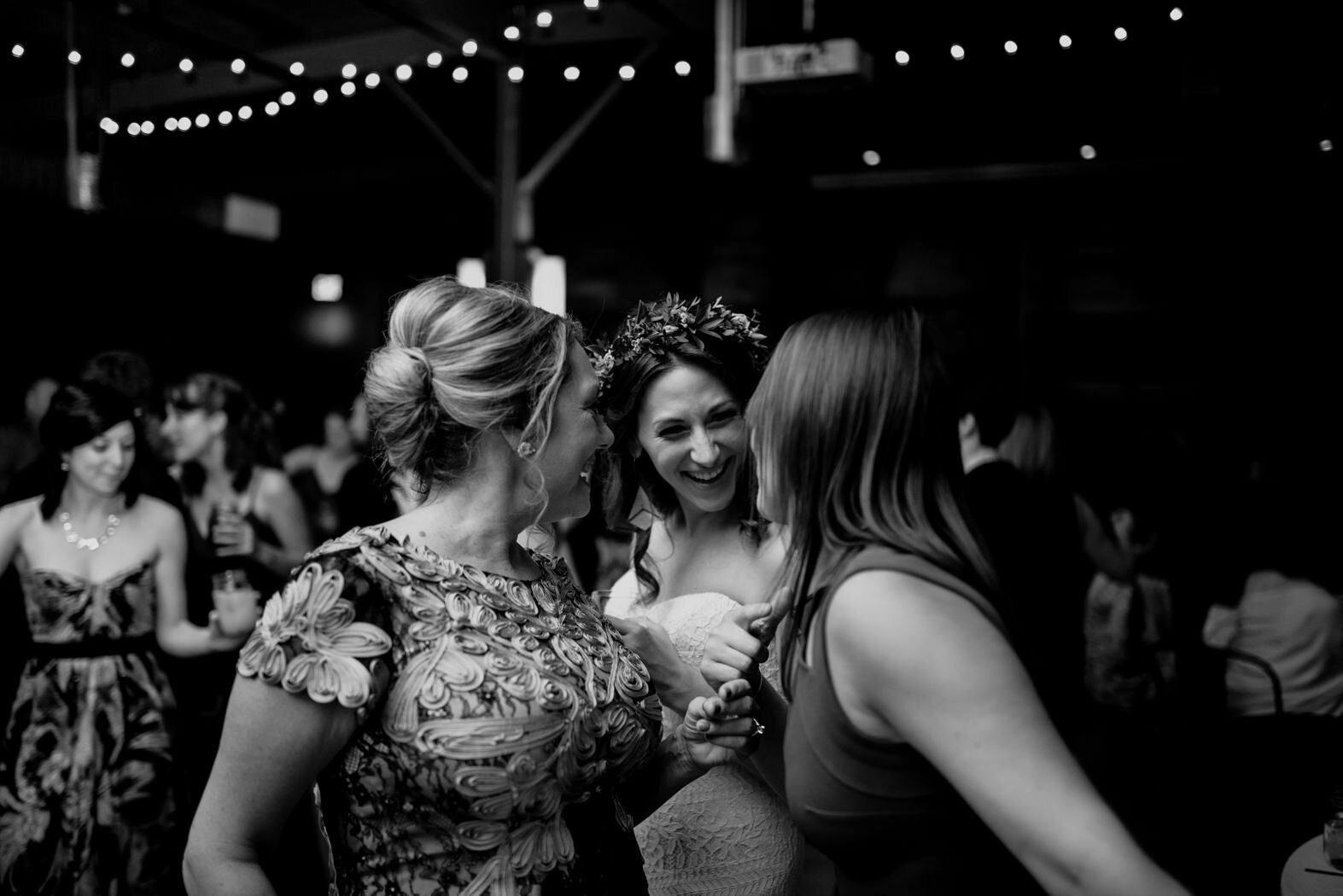 the bride, her mother and her sister dancing during the reception