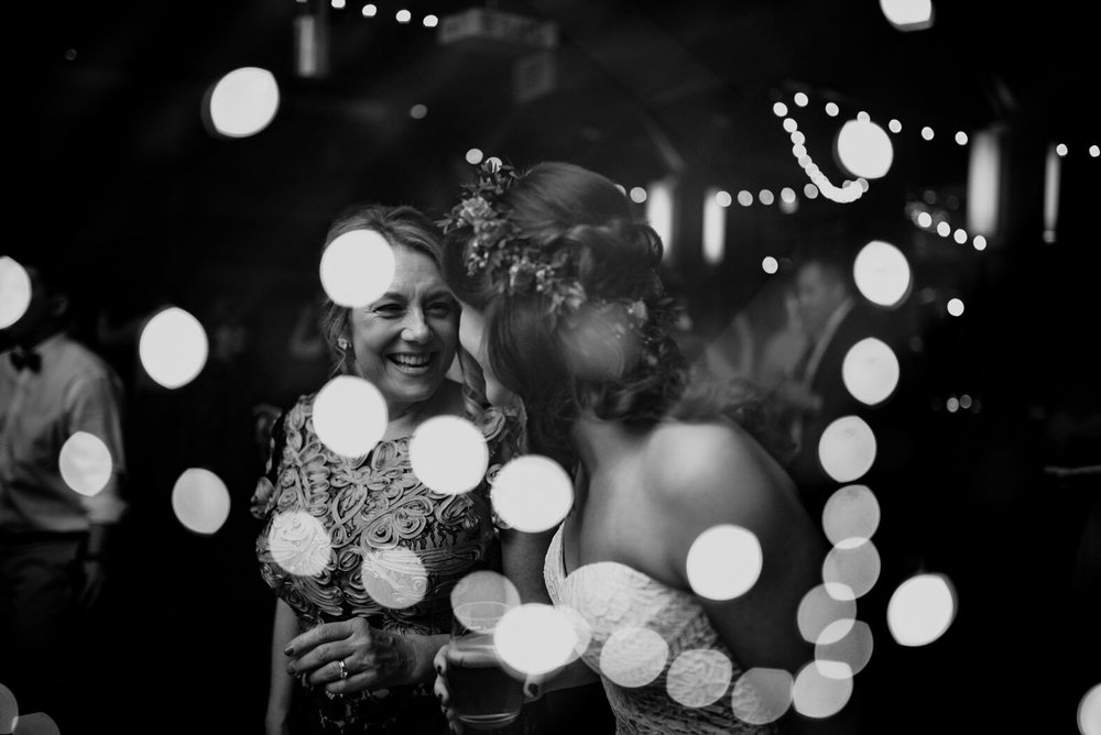 a multiple exposure of the bride and her mother talking overlayed with the market lights