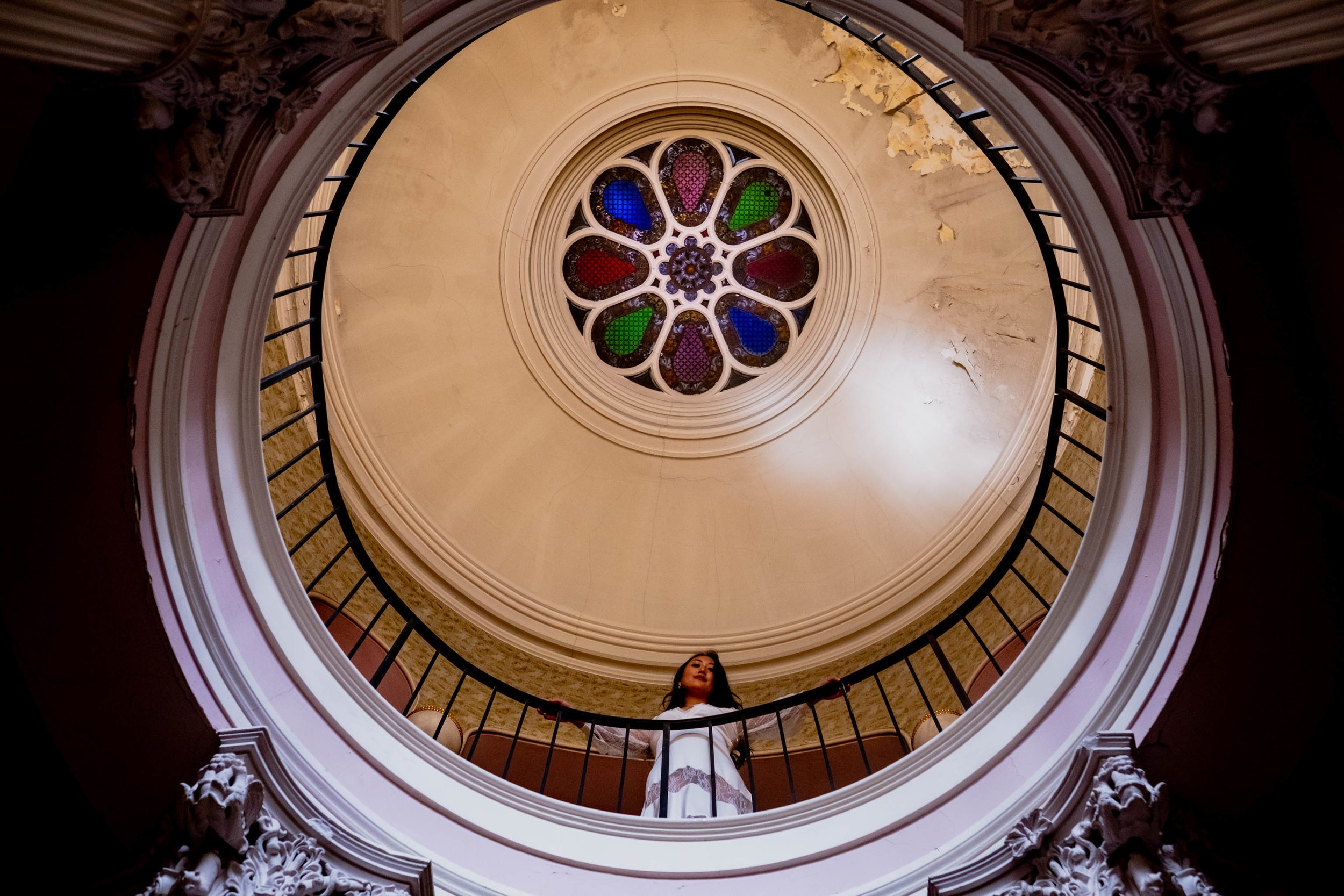 Bride standing underneath the stained glass cupola of the Montfort House in Raleigh, NC