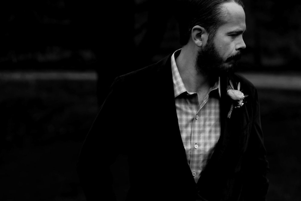 black and white photo of groom in his suit