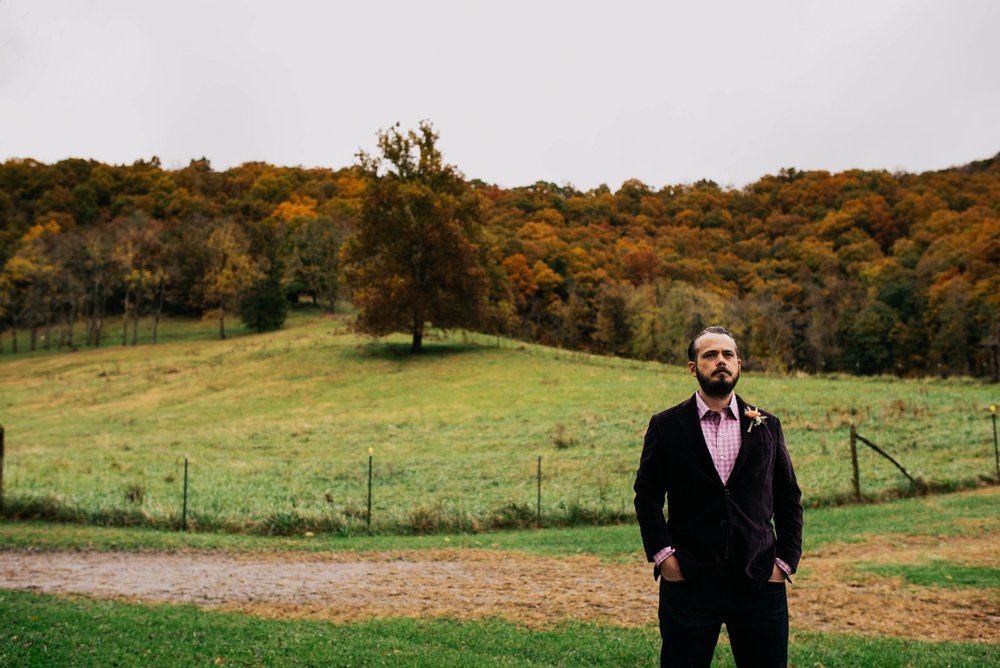 groom waiting for his bride by the paddock of this mountain farm