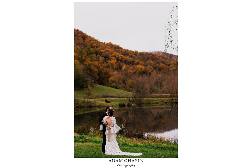 bride and groom standing together with mountains full of fall colors behind them