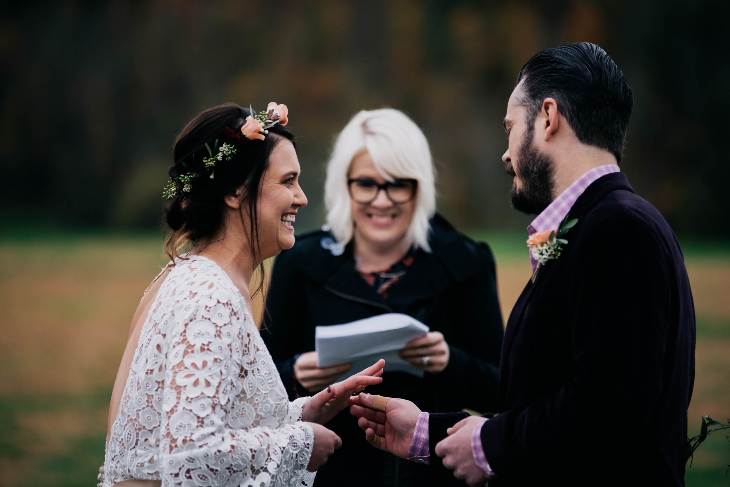 groom placing the wedding ring on his bride