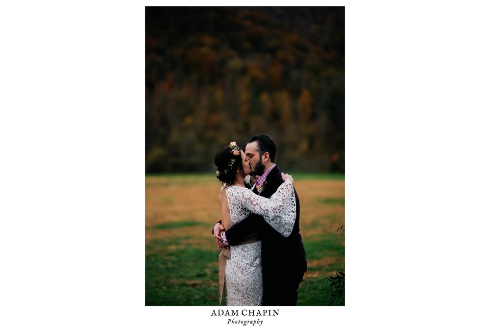 bride and groom sharing in their first kiss