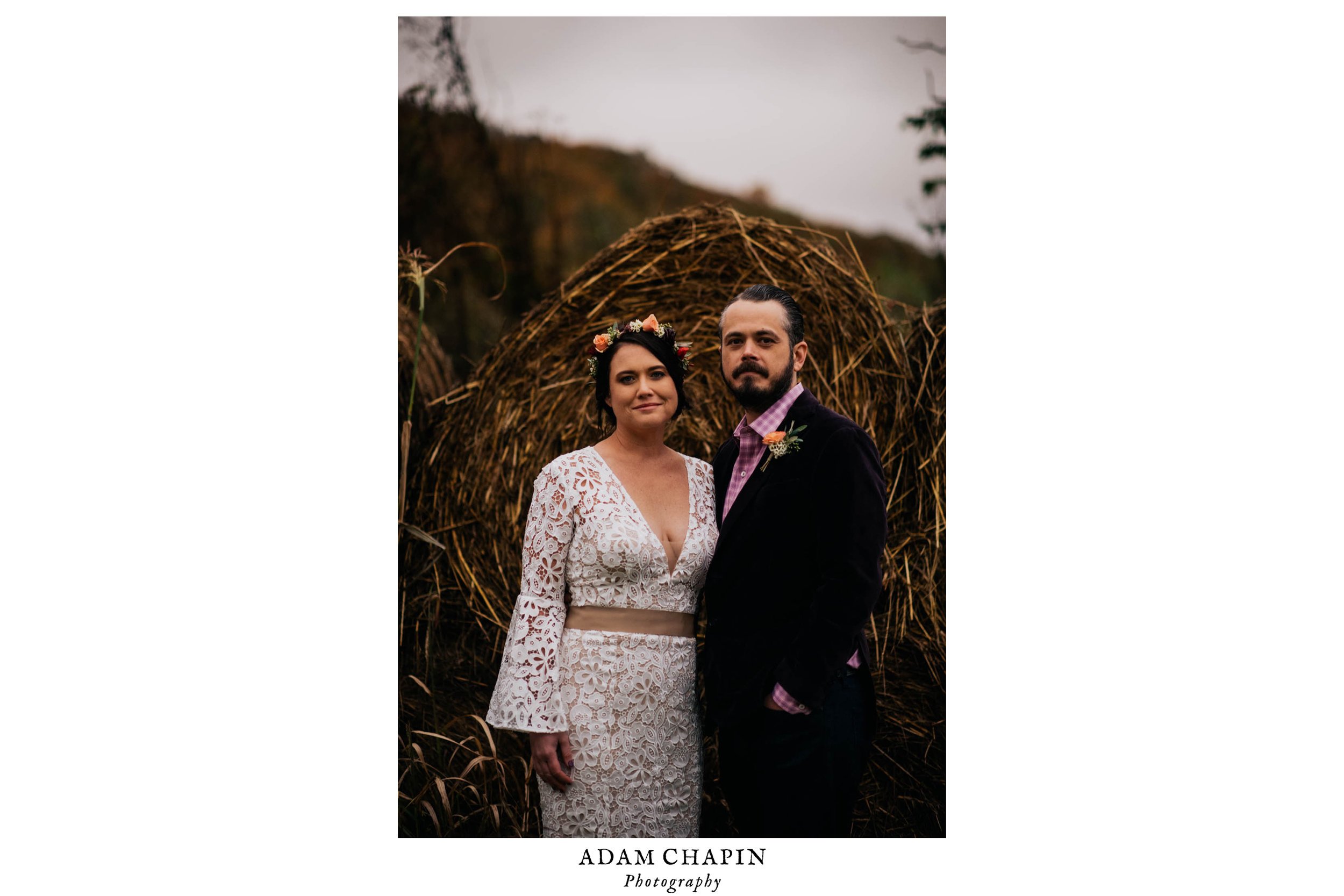 bride and smiling  and posing in front of the hay bails