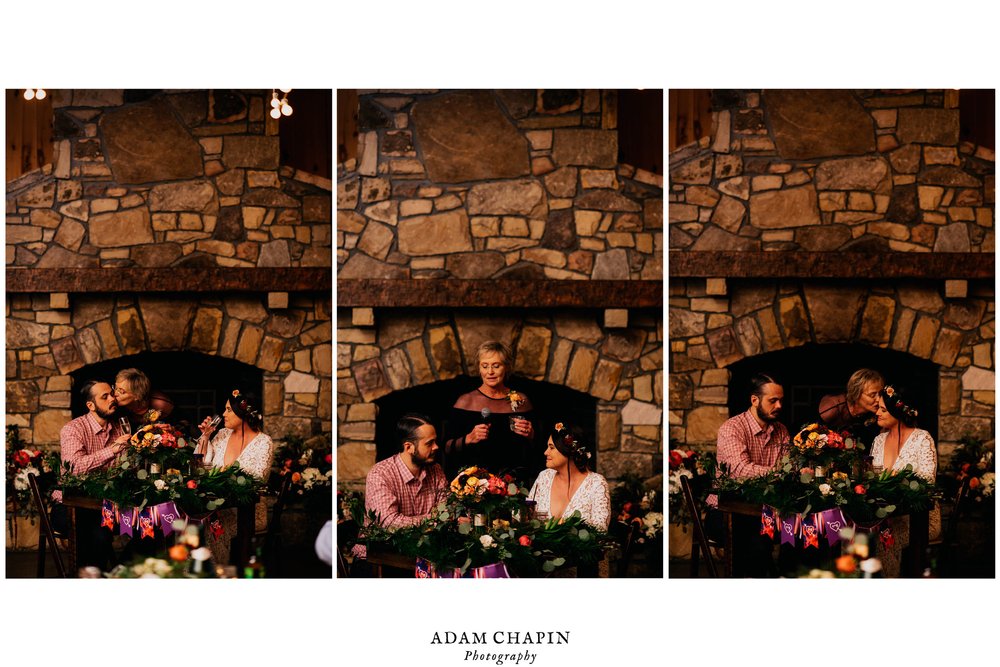 mother of the bride sharing a toast and a kiss with the bride and groom during the reception