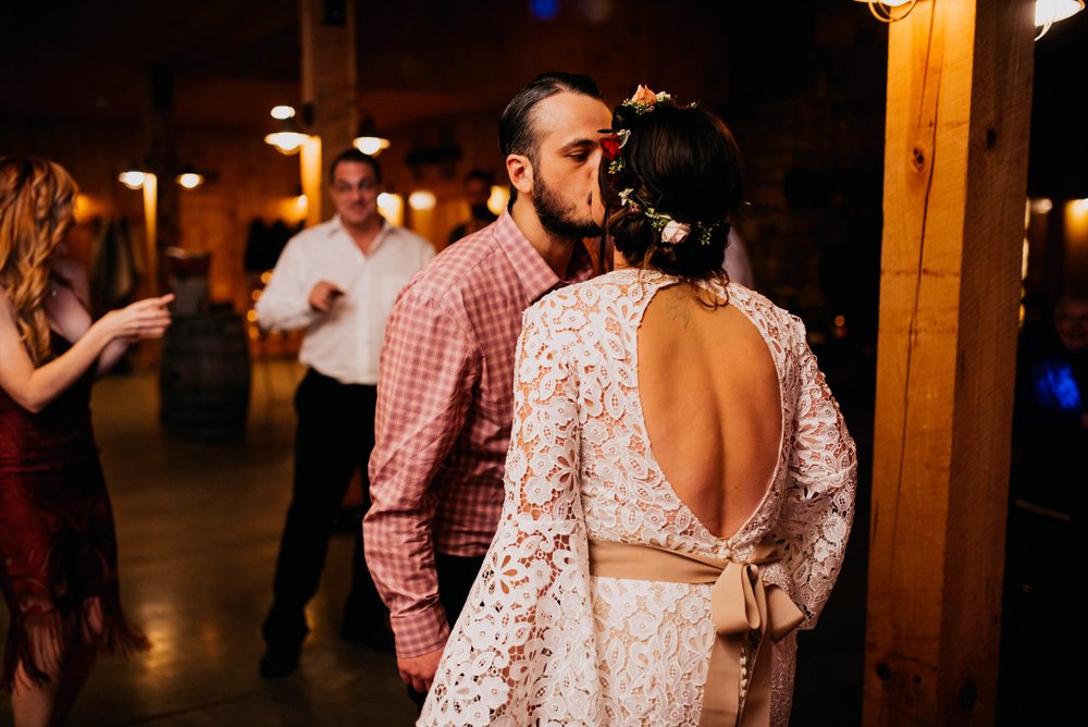 bride and groom kissing during a dance at their reception