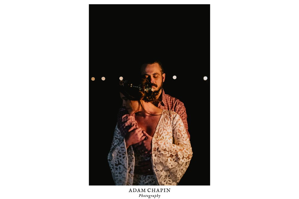 bride and groom sharing an intimate moment by the fire at their wedding