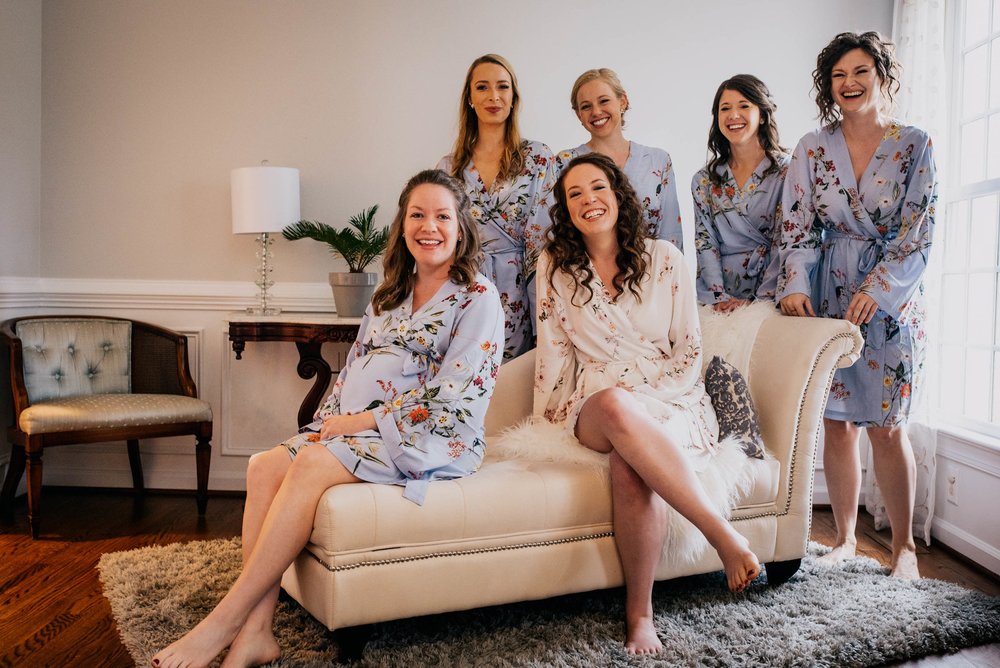 portrait of the bride and her bridesmaids in their custom robes before they get ready for the wedding day