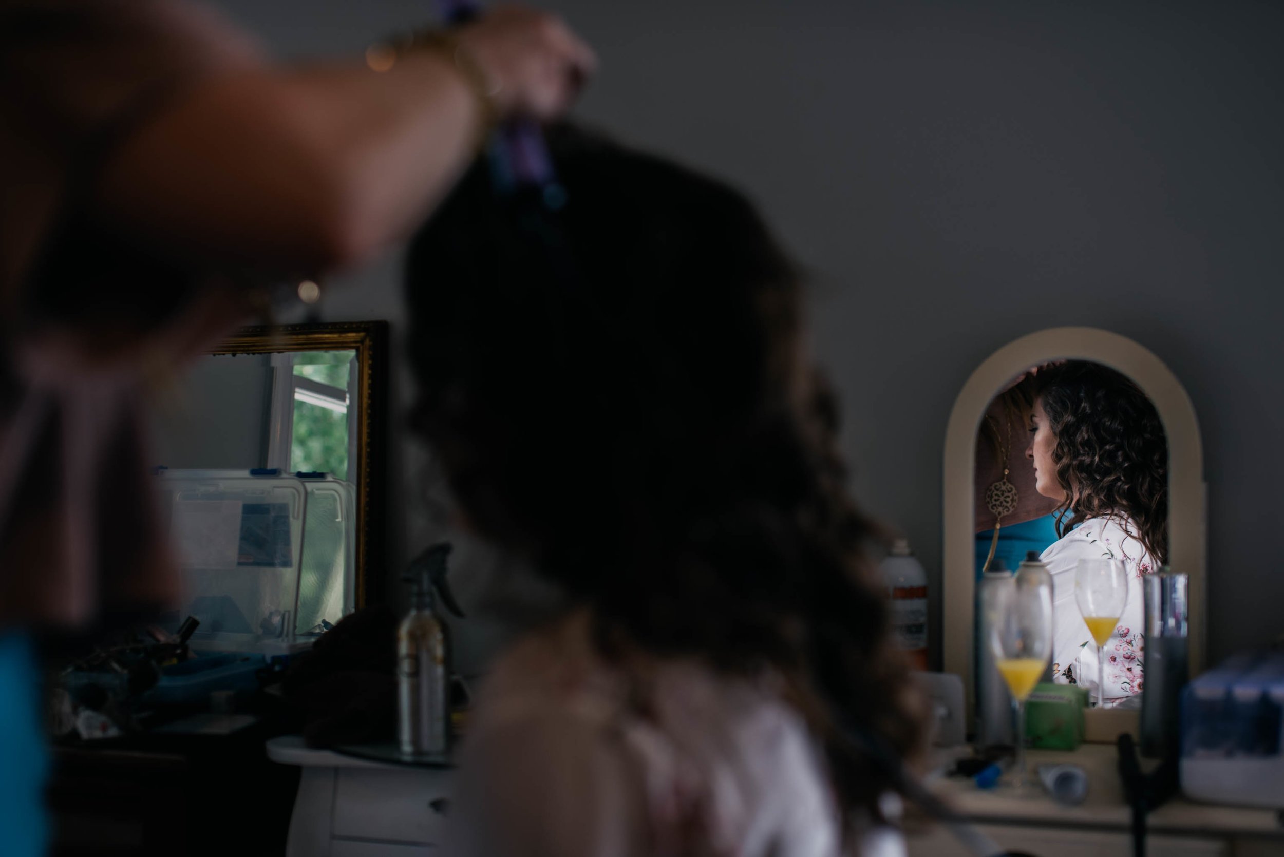 reflection of bride as her hair is finished up