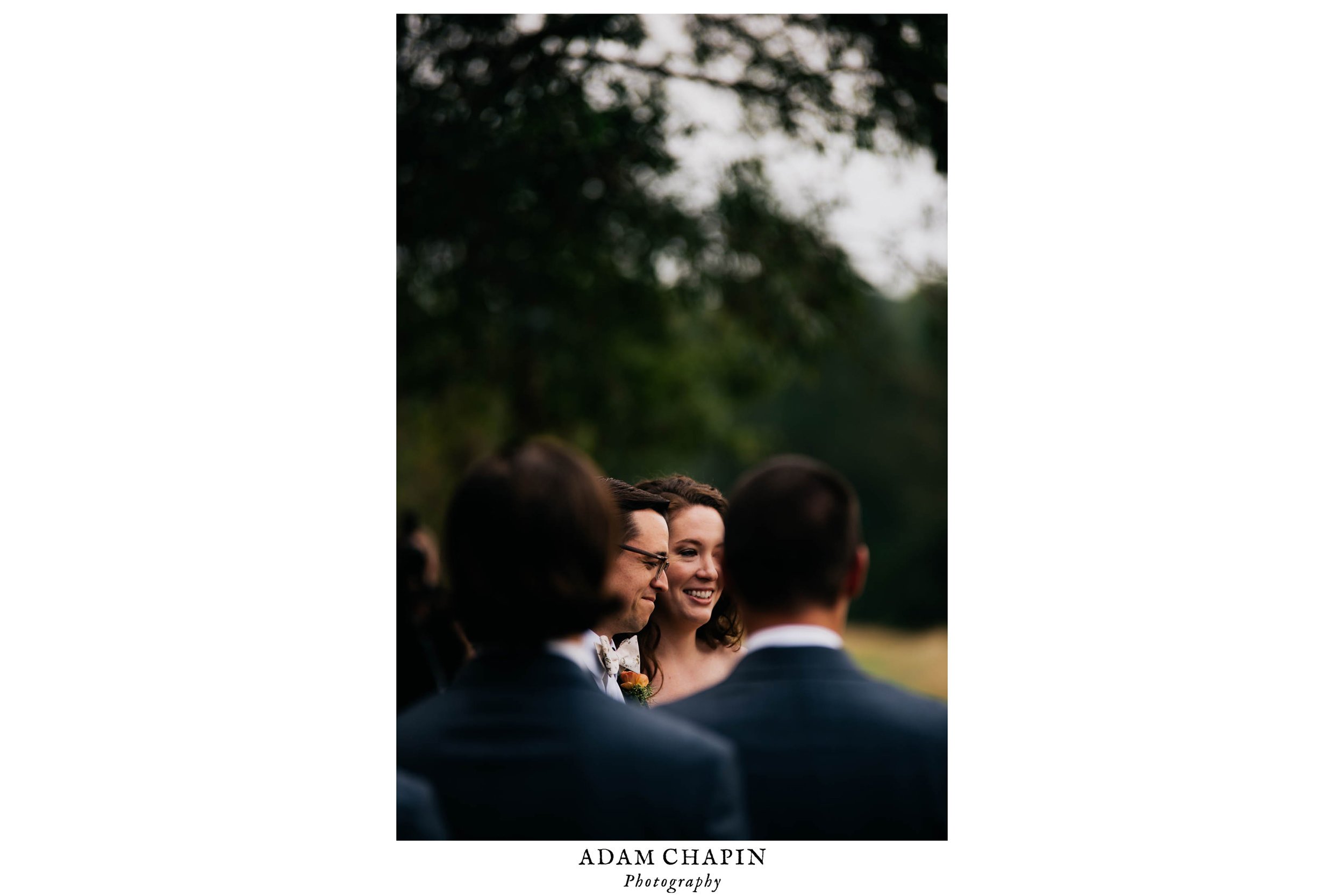 bride and groom listening to the wedding officiant during their ceremony