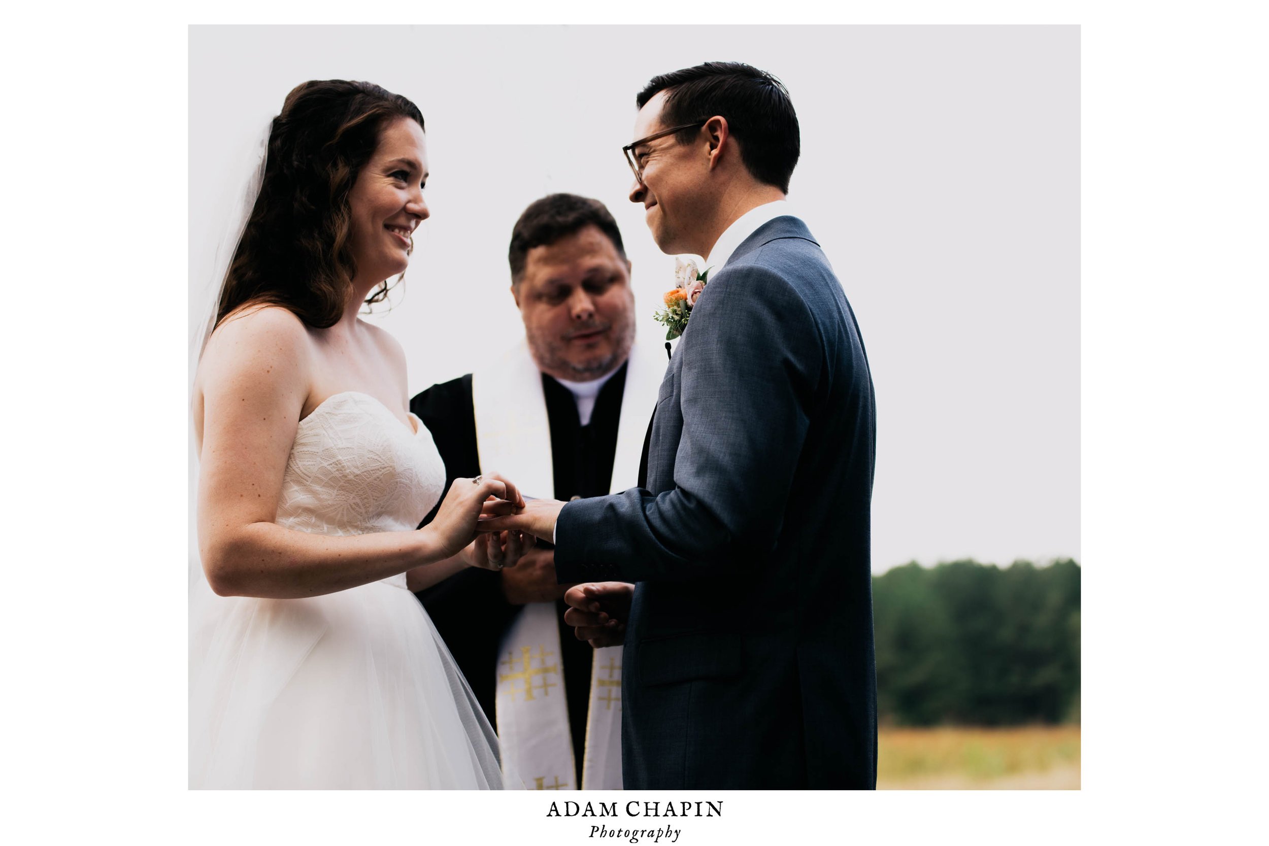 bride and groom smiling at one another during their wedding ceremony