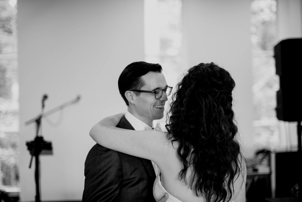 black and white photo of the bride and groom enjoying their first dance