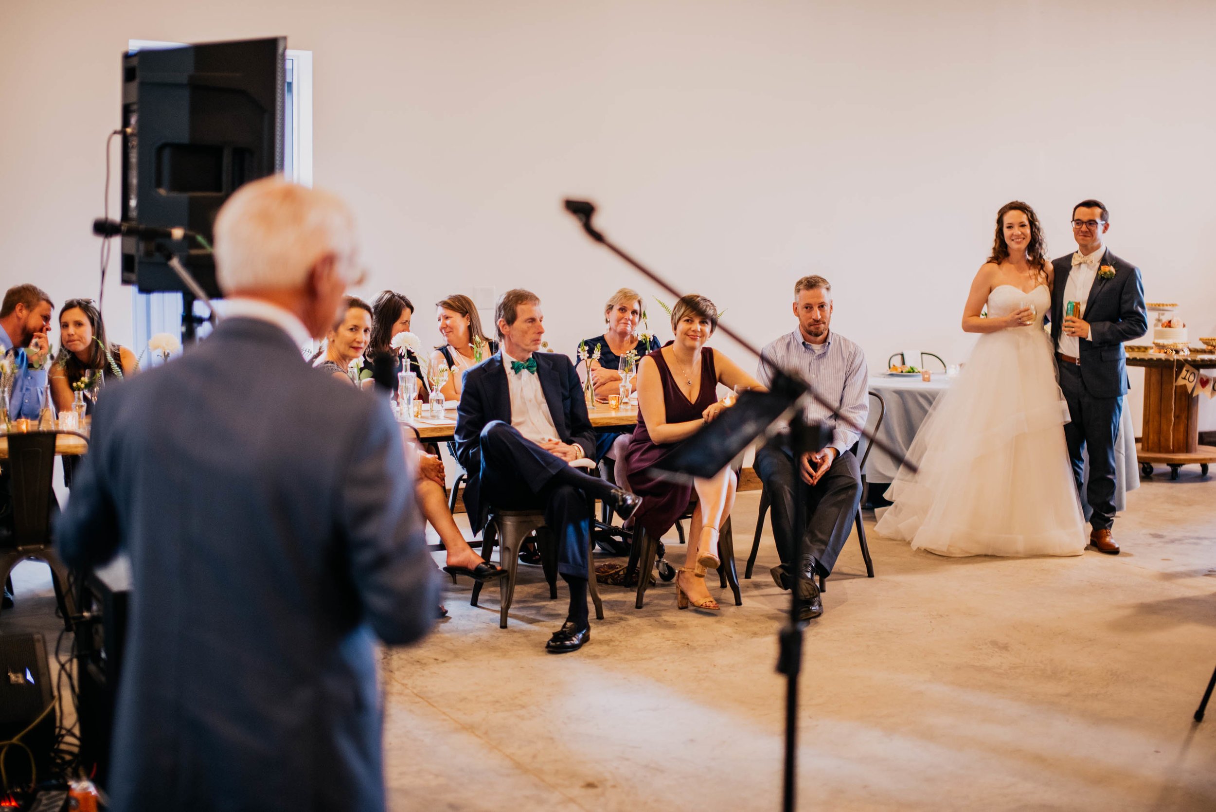 grooms father sharing a toast during the wedding reception