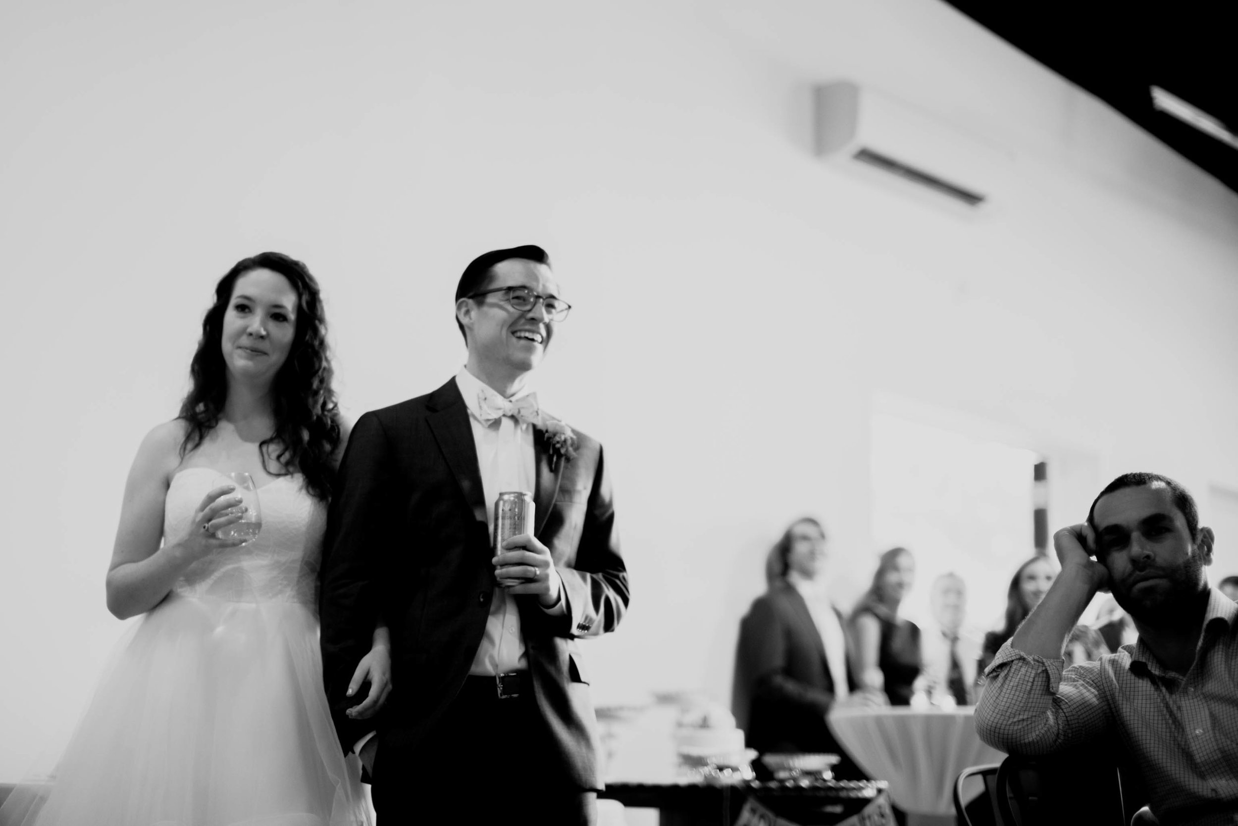 bride and groom listening to toasts during their wedding reception