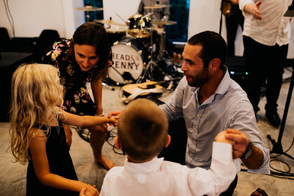 wedding guests dance with their kids during the wedding reception