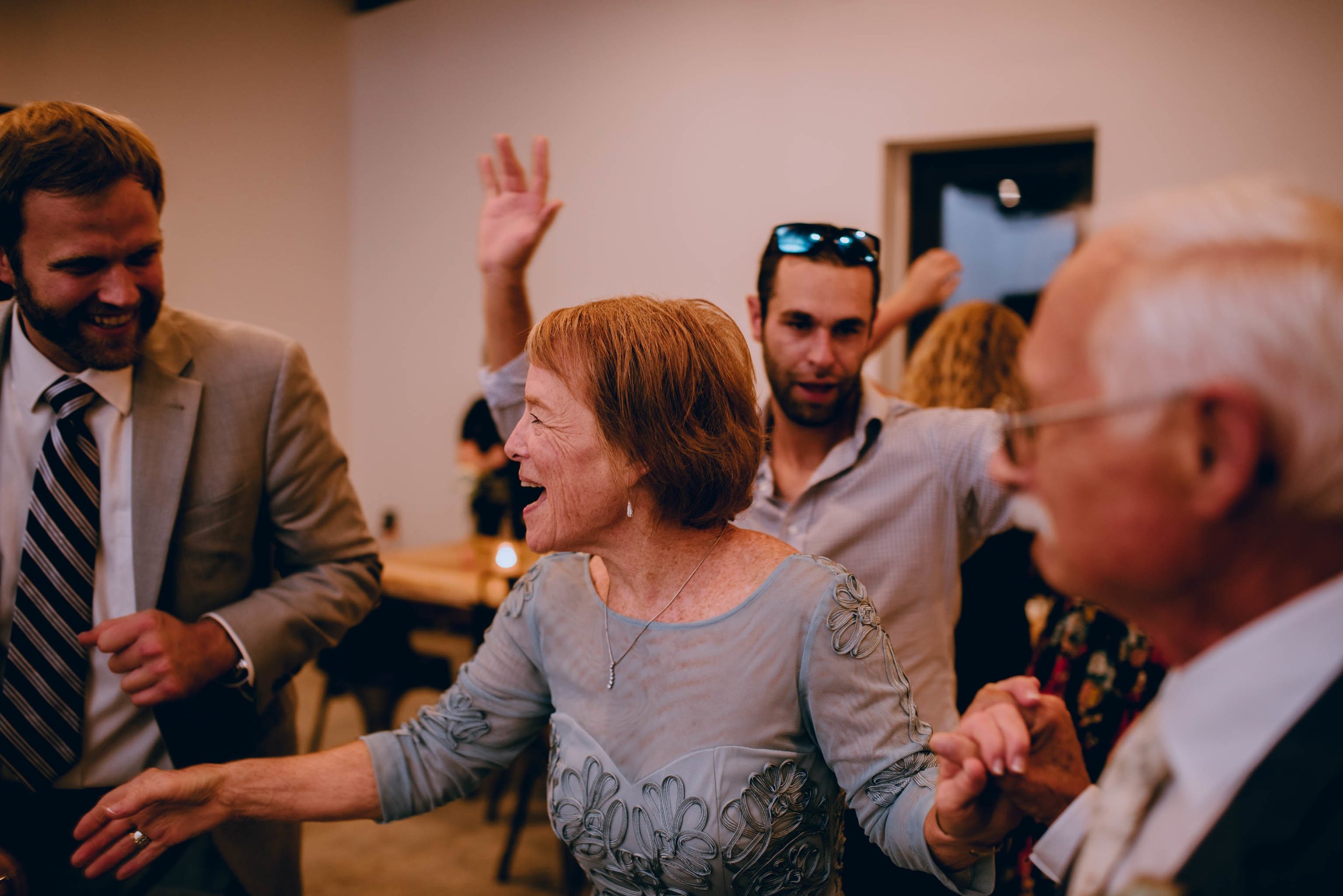 mother of the groom dancing with wedding guests