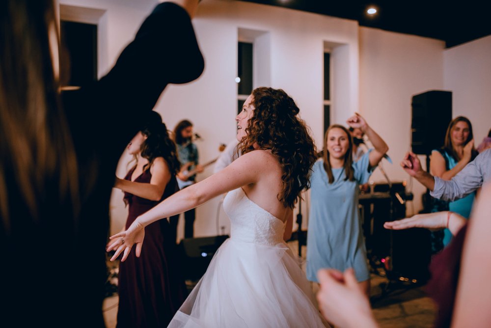 bride dancing with her bridesmaids during wedding reception