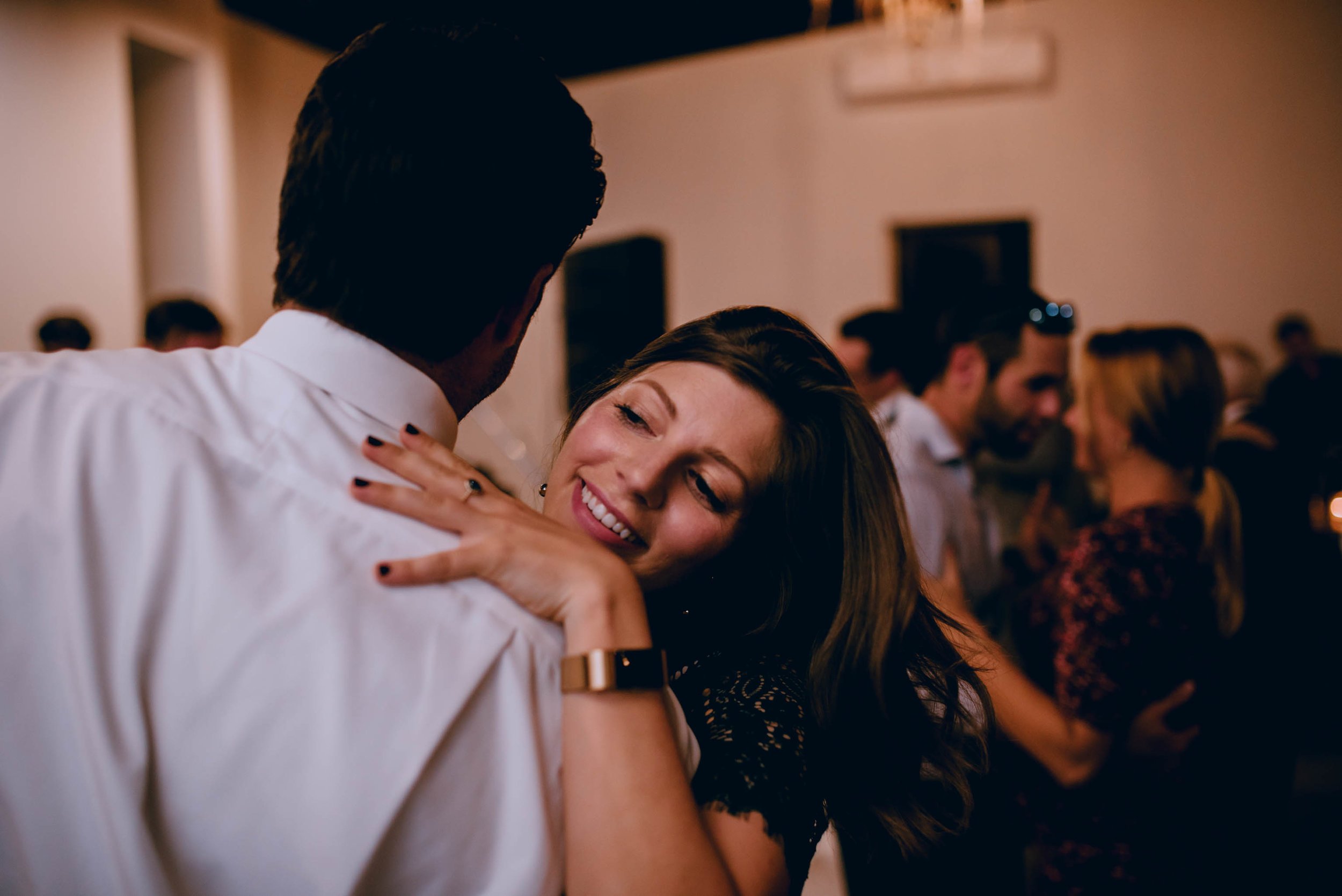 wedding guests dancing and laughing during wedding reception