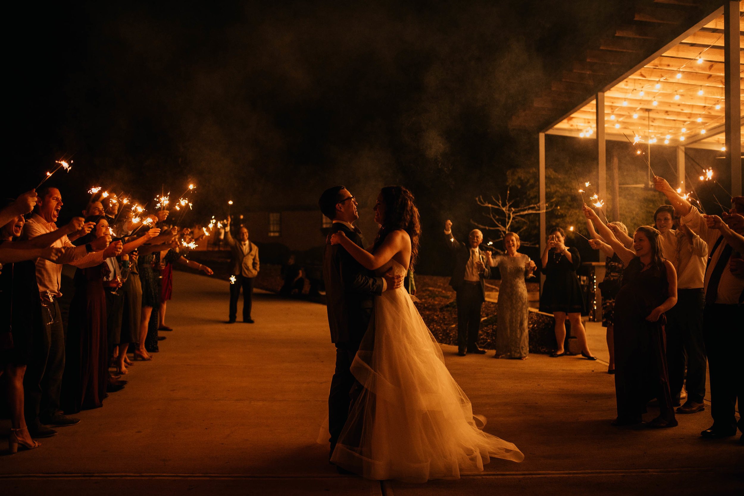 bride and groom share one last moment during sparkler exit on their wedding evening